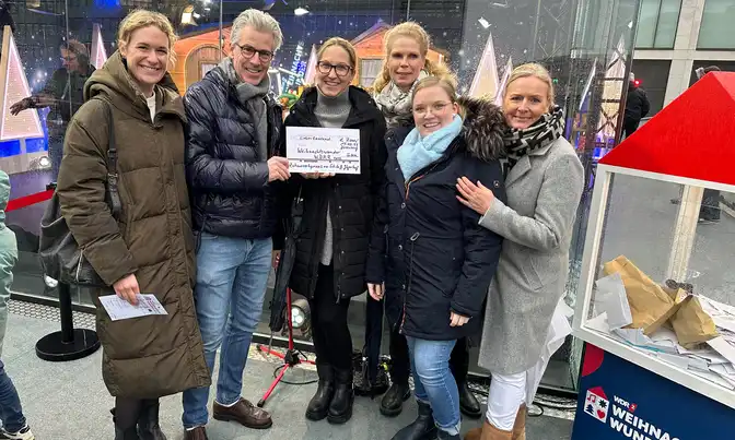 Das Praxisteam mit einem Spendenscheck