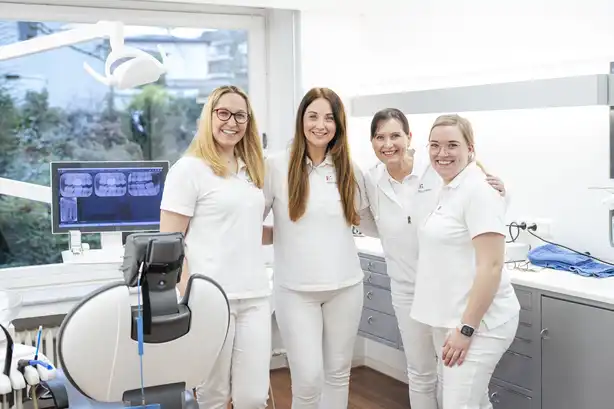 Das Team von Dr. Tom Froböse steht in einem Behandlungszimmer